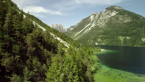 Aerial view of Lago del Predil surrounded by hills in Cave del Predil, Itally.