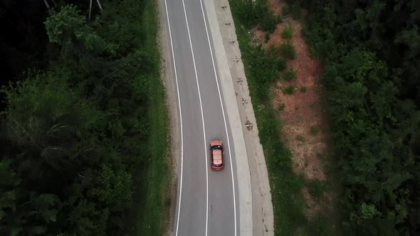 Drone Point of View Tracking Mode Aerial View Flying Over Two Lane Countryside Forest Road with