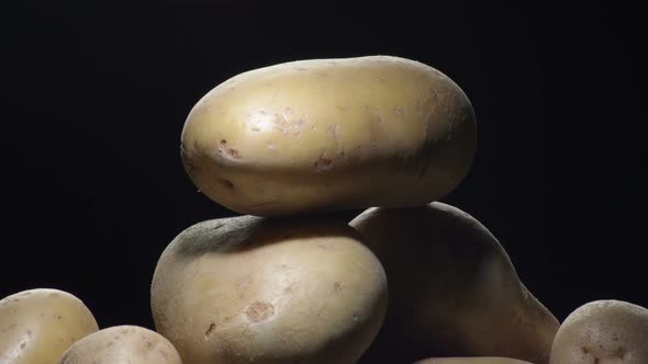 Potatoes Gyrating on Black Background