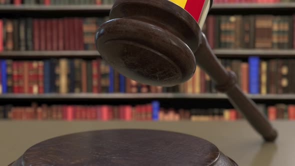 Flag of Romania on Falling Judges Gavel in Court