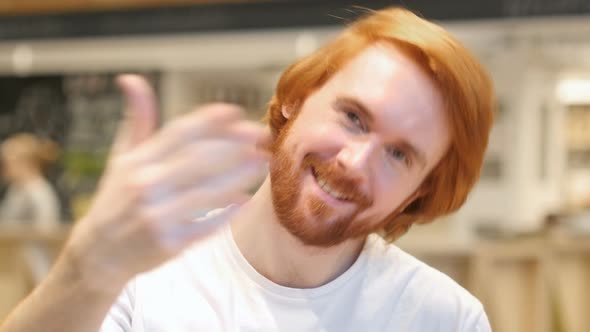 Portrait of Redhead Beard Man Inviting Customers in Cafe