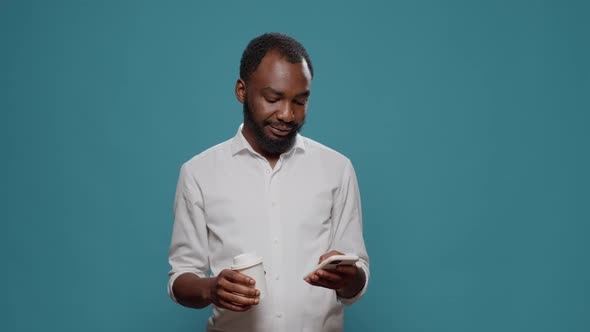 African American Man Browsing Internet on Smartphone