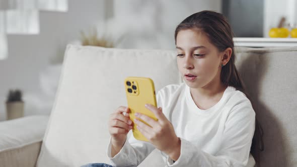 Pretty Teen Looking on Mobile with Surprised Emotions