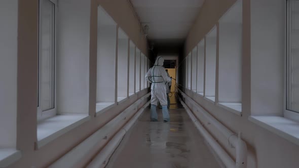 Workers Spray a Disinfectant Solution in an Elevated Passage