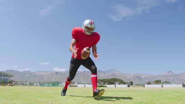 American football player kicking a ball