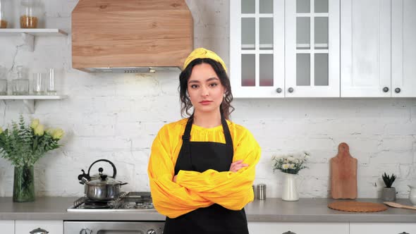 Portrait Serious Woman Housewife Crossing Hands Looking Camera in Home Kitchen