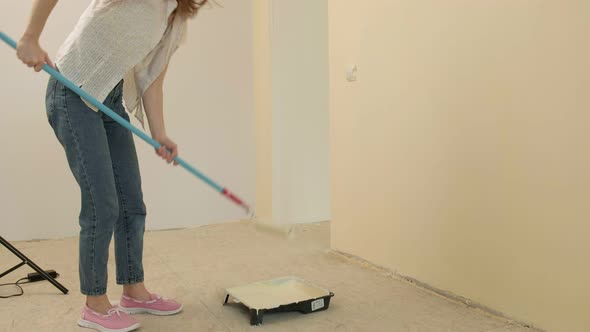 Female House Painters Paint the Walls in the Room.