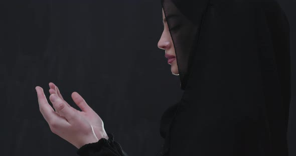 Portrait of Beautiful Muslim Woman in Fashionable Dress with Hijab Making Traditional Prayer to God