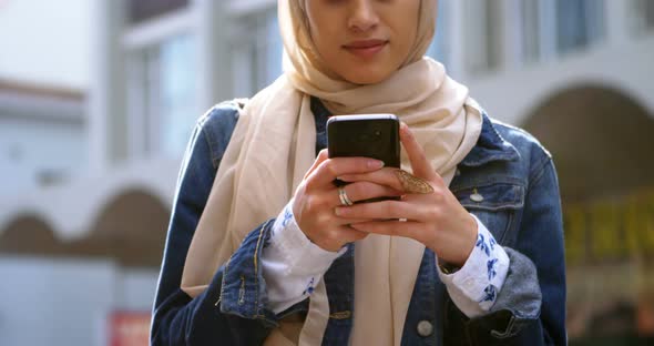 Woman in hijab using mobile phone 4k