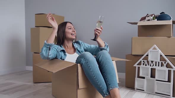 Happy Caucasian Woman Sitting Inside Packing Box