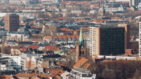 City centre  of the Norwegian capital, Oslo. Oslo Domkirke between the roof tops.4k telephoto pan.