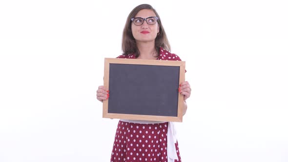 Happy Beautiful Woman with Eyeglasses Thinking While Holding Blackboard