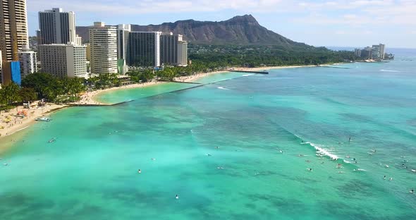 Surfers riding waves by the exotic Waikiki beach,Honolulu,Hawaii,