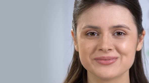 Beautiful Young Woman Smiling at Camera, Healthy Teeth and Clear Skin Healthcare