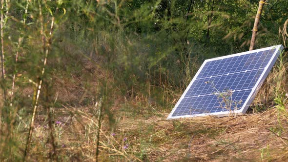 Portable Solar Panel Lying on the Ground Used in Tourism and for Camping