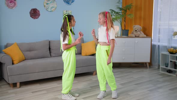 Stylish Girlfriends Learn to Dance at Home Female Children with Bright Pigtails and Similar Clothes