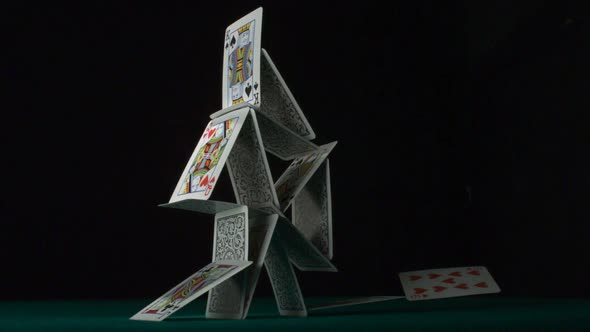 Pyramid house of playing cards falling down, Slow Motion