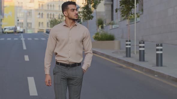 Hispanic Young Guy Arabian Businessman Walking Near Modern City Building Background