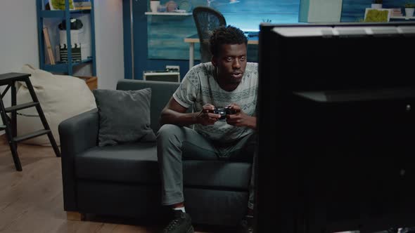 African American Man Losing at Video Games on Console