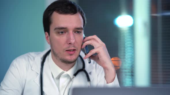 Doctor In Office With Phone