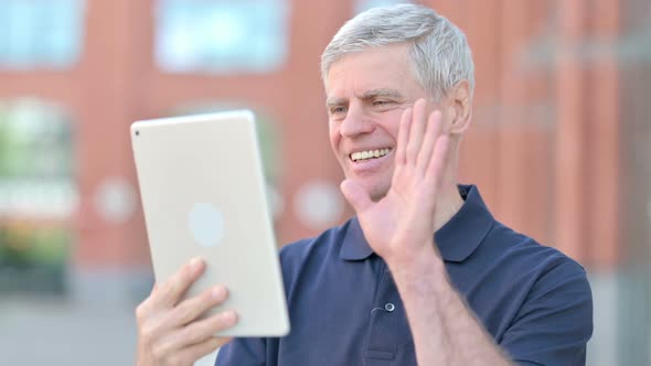 Outdoor Middle Aged Man Doing Video Chat on Tablet