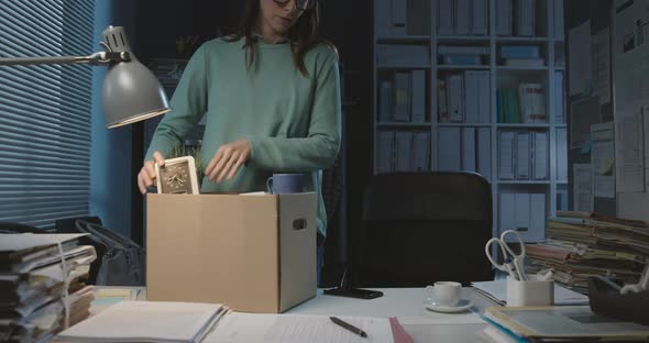 Woman packing her belongings after losing her job