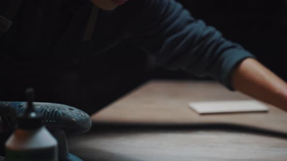 Young Active Man Shakes the Dust Off the Table