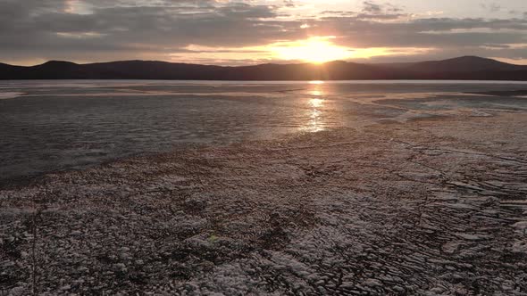 Aerial View of Sunset Over the Frozen Winter Sea