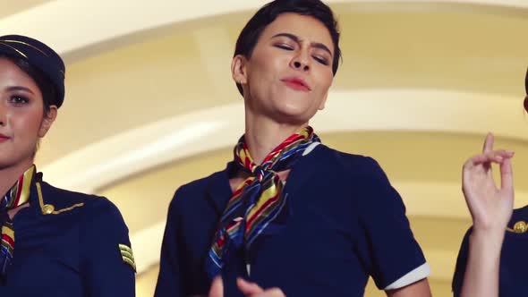 Cabin Crew Dancing with Joy in Airplane