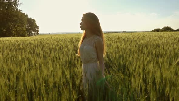 Girl Walking in Field at Sunset Slow Motion