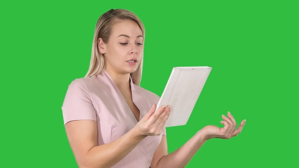 Happy woman chatting over a video call by using a tablet