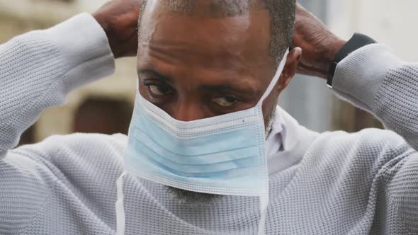 African american man on the go wearing coronavirus covid19 mask