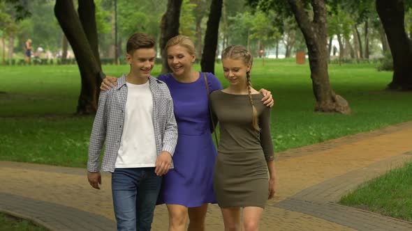 Teenage Boy and Girl Walking With Mother in Campus, Planning on Starting College
