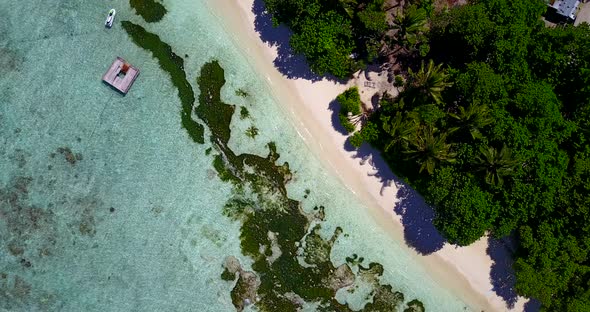 Wide angle above tourism shot of a white sand paradise beach and turquoise sea background in vibrant