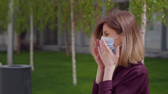 Business woman puts on face medical mask to protect sitting on bench park city