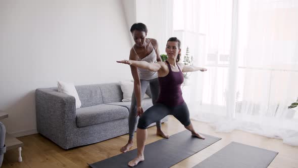 Two women exercising in living room