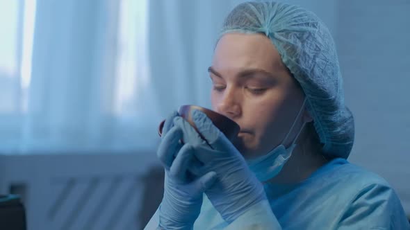 Closeup Young Female Surgeon Tea Drinking Tea Indoors Smiling Looking Away