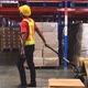 black male warehouse worker pulls a pallet jack with boxes and goods to unload the stock. - VideoHive Item for Sale