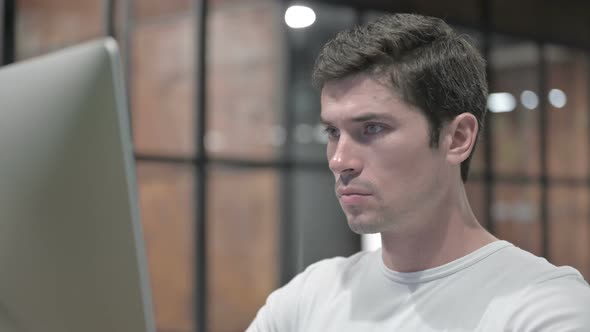 Close Up of Young Man Working on Laptop