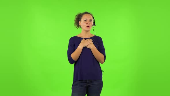 Curly Woman Talking on Headphones, Call Center. Green Screen