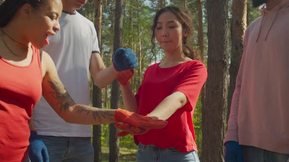 Diverse Eco Volunteers Making Pile of Hands Outdoors