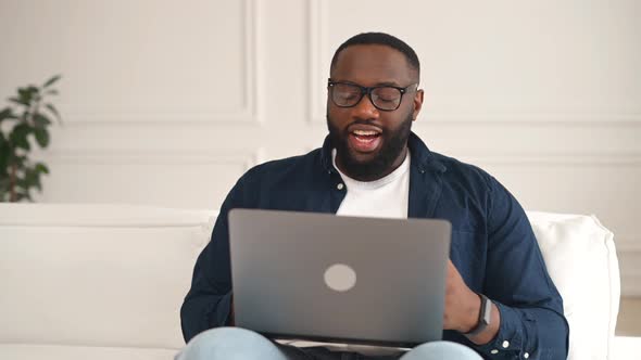 Excited Happy 30s African Guy Enjoying Virtual Meeting