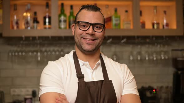 close-up portrait of a confident smiling bartender at the bar