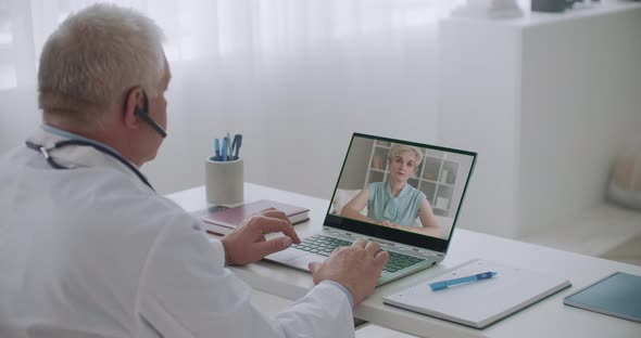 Female Patient Is Consulting with Experienced Medical Specialist By Video Calling, Man Is Using