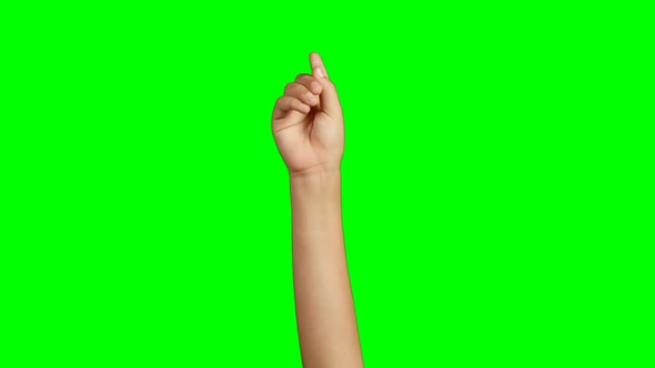 Person making hand gesture against green screen background