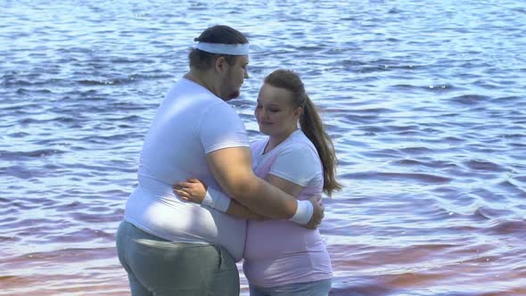 Beautiful Overweight Couple Hugging on Riverbank, Romantic Date and Tenderness