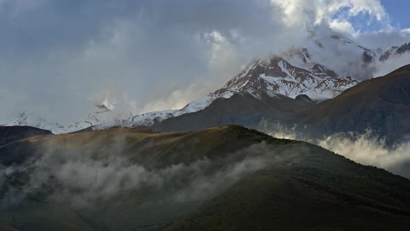 Timelapse of clouds move along mountains