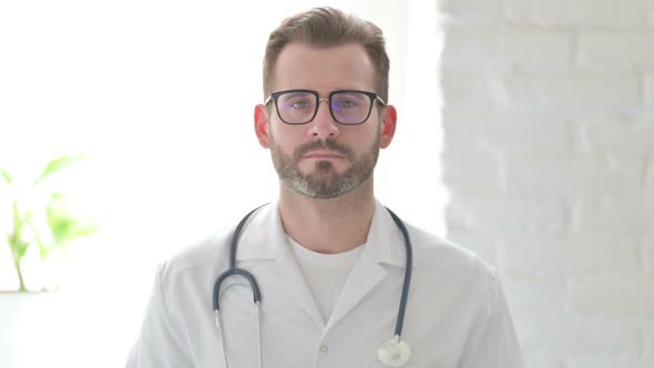 Portrait of Serious Doctor Looking at the Camera