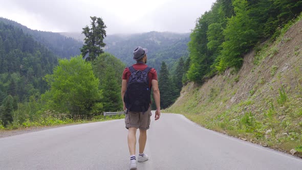 Man walking on empty road.