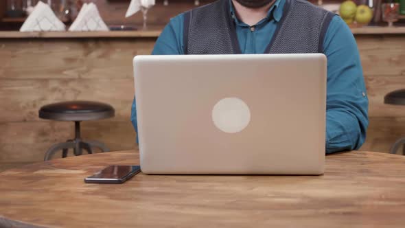 Waiter of a Coffee Shop Brings a Cup of Coffee and Puts It on the Table